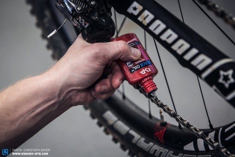 Cleaning the chain on a mountain bike.