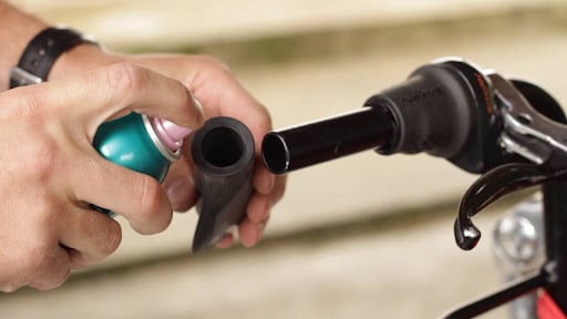 When installing slip-on bike grips, use a spray adhesive to secure the grips easily.