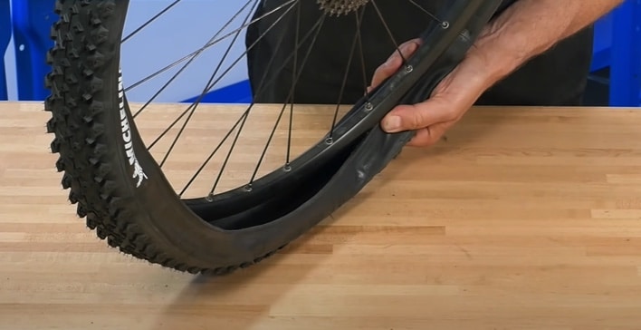 You will need to leave a part of the tubeless tire loose from the rim so that you can add the tire sealant.