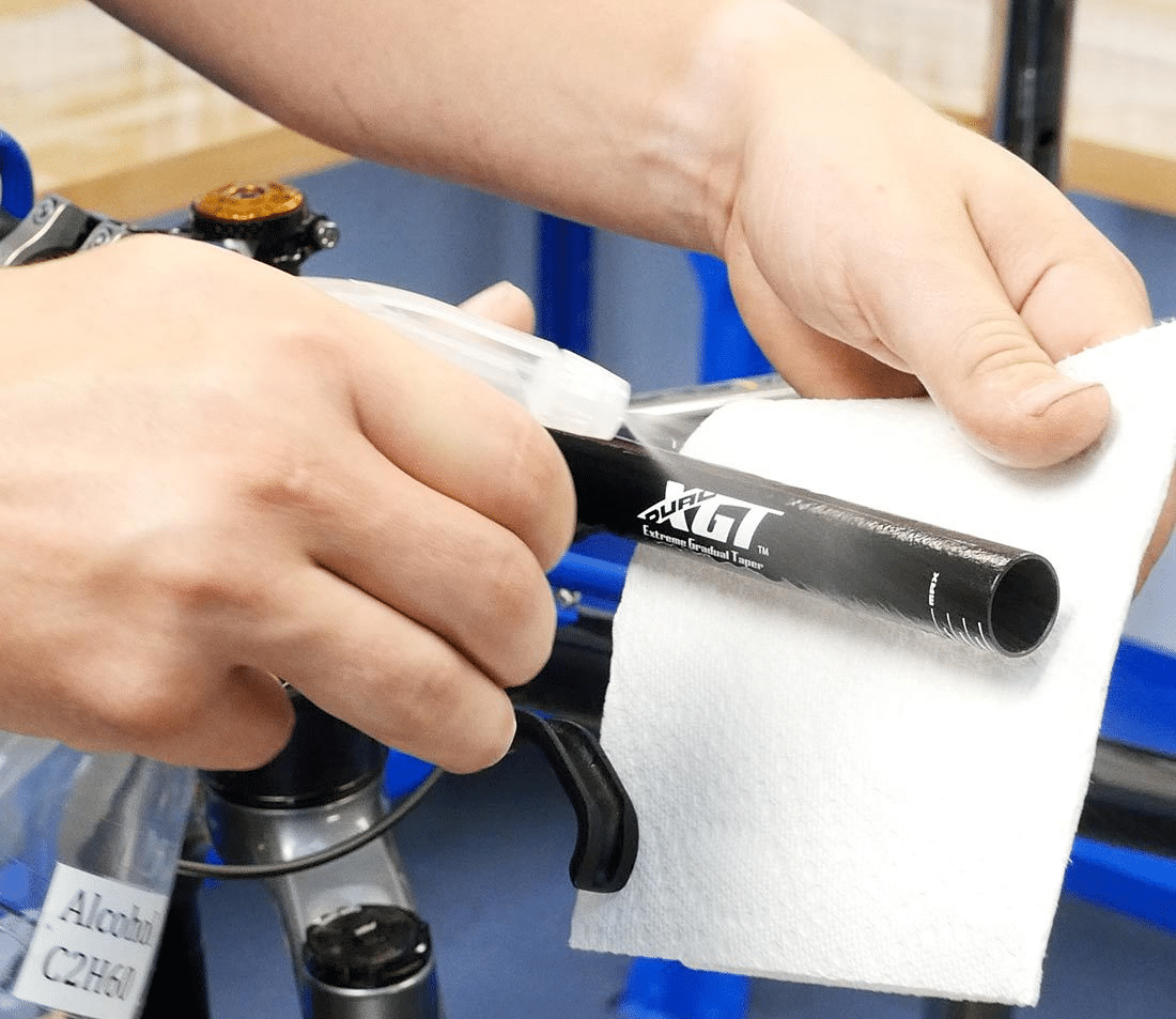 Use a substance such as Isopropyl alcohol to clean handlebars when attempting to fix a mountain bike grip that has fallen off.