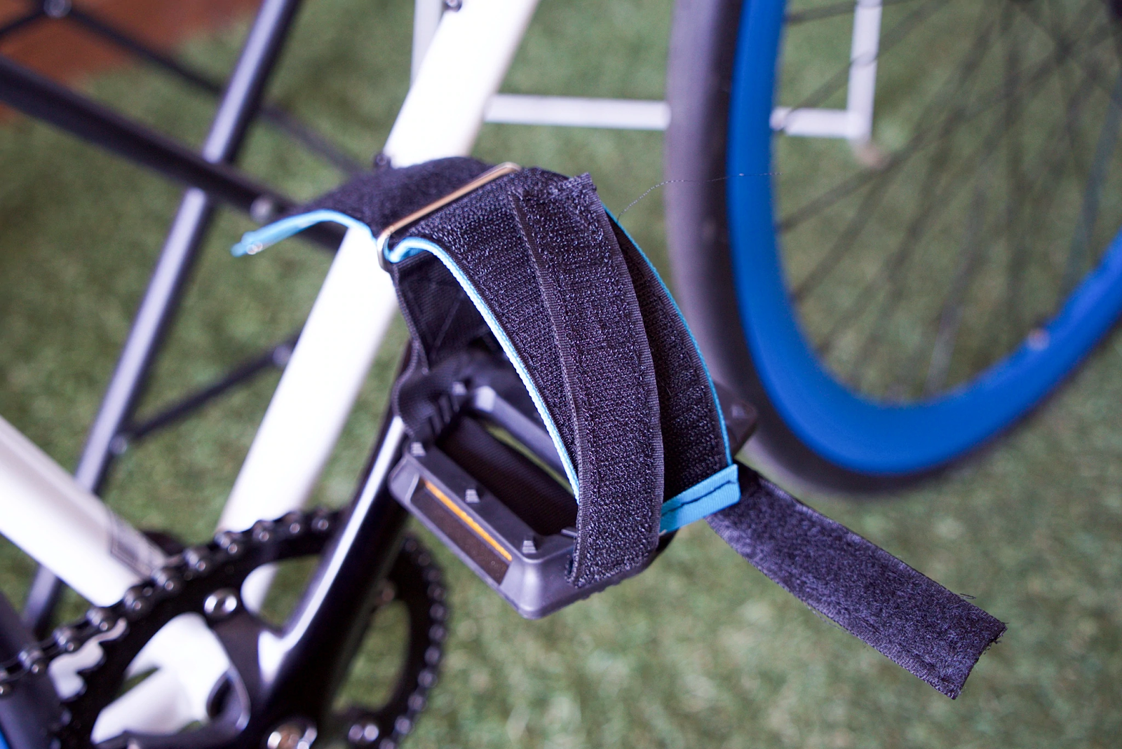 The two straps that are threaded through the pedal will be folded upwards and attached over the section of the pedal strap that goes over the rider's foot.  