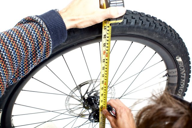 Measuring the diameter of the mountain bike wheel and tire is a good way to determine its size.