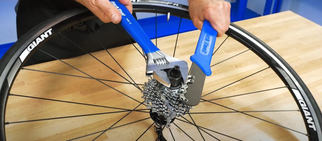 To remove the lockring position the lockring tool, the chain whip, and the wrench so that you can loosen it.