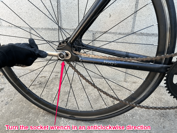 To loosen the back wheel use a socket wrench to rotate the nut in an ant-clockwise direction.