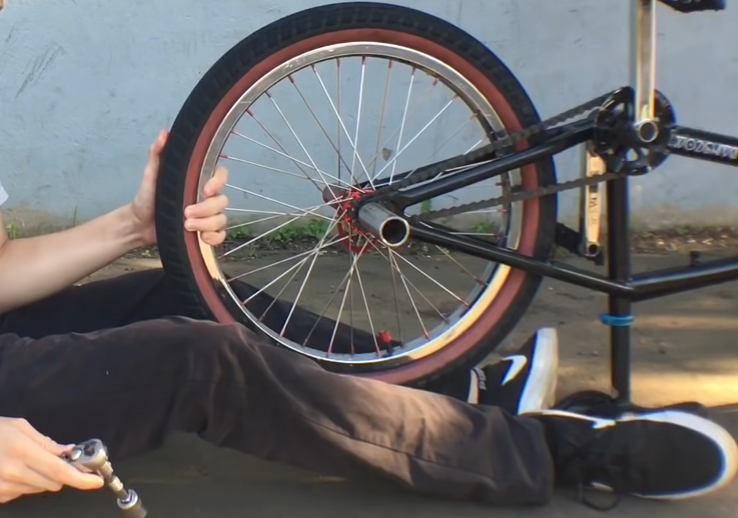 Push against the seat while pulling the wheel toward you to loosen it.