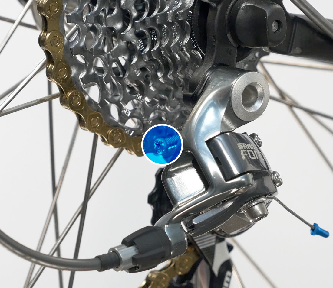 Locate the B screw to tighten the chain of a mountain bike with a derailleur. 