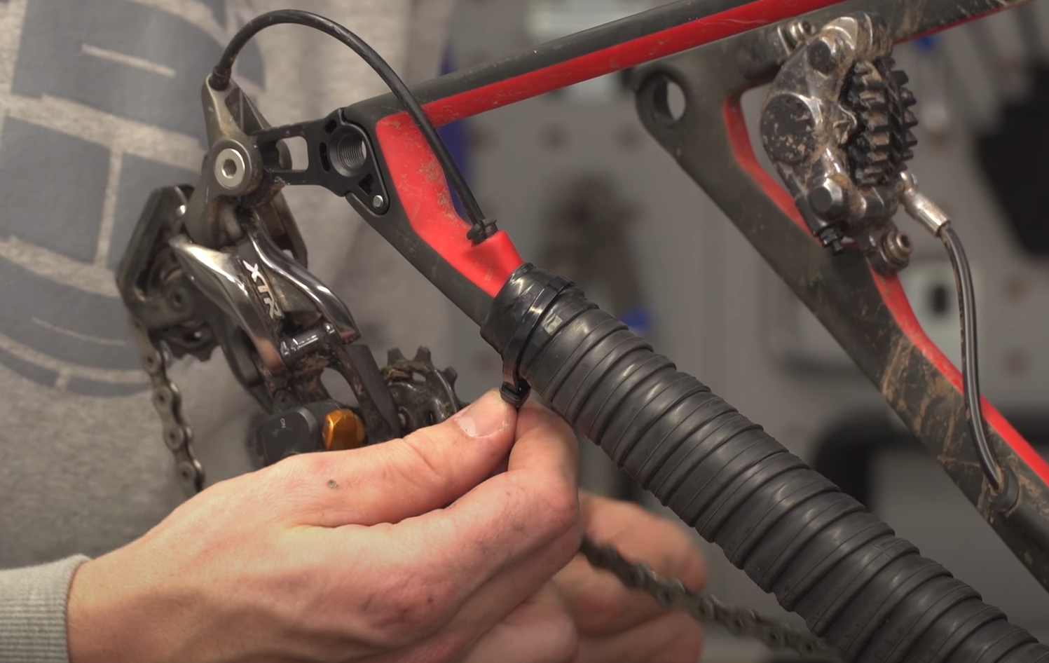 Once you have wrapped the tubing around the entire length of the chain stay, secure the ends to the bike’s frame using electrical tape like this. 