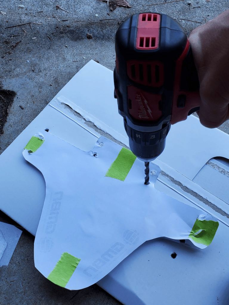 To make sure that you drill holes in the right spots, stick the template onto the mudguard using tape like this.