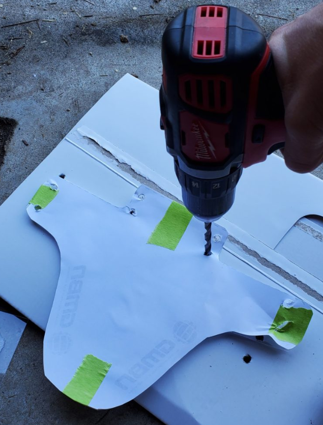 Make your mounting holes using a drill or a paper hole punch.