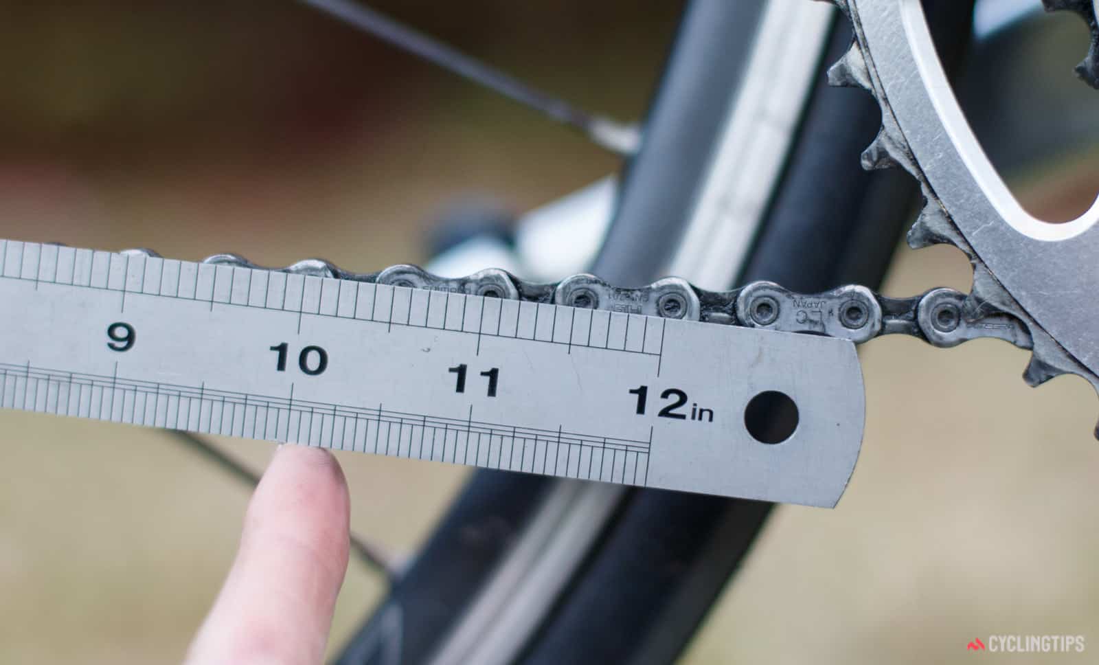 You can also simply use a ruler to see whether your chain is slightly longer than it should be due to stretching.
