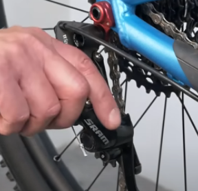 Once the wheel is in place and the chain is looped over the cogs reposition the derailleur. 