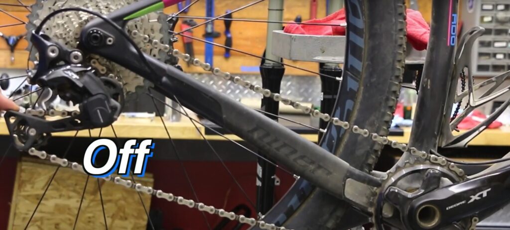 To release the tension of the chain, disengage the derailleur clutch mechanism. 