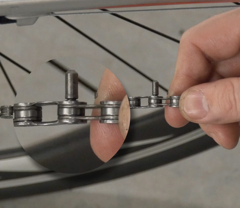 When fixing a mountain bike chain using a connector pin push the pin all the way through until the pilot tip is protruding on the other side of the chain and then break it off.