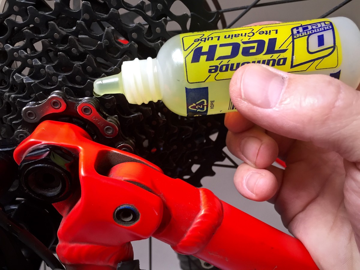 Apply a drop of lube to each link of your mountain bike chain by holding the bottle in one position and rotating your pedal backward so that you can cover the entire chain.