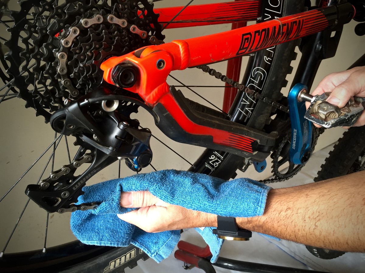 Use a clean dry cloth to wipe off any excess lube by holding the chain gently and rotating the pedal backward.