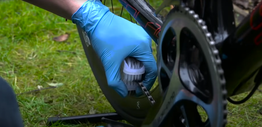 Brush a degreaser onto the mountain bike chain.