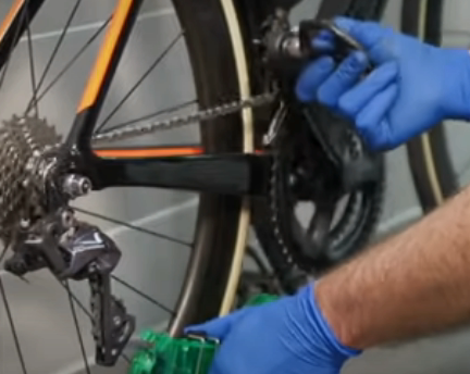 The brushes inside the chain cleaner brush off dirt and grime as the chain moves through it slowly. 