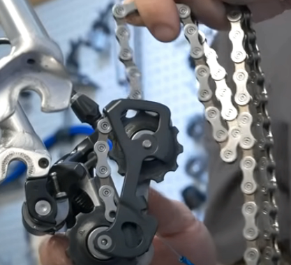 When your chain is clean and you are sure that it is dry, thread it through the rear derailleur.