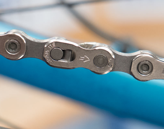 The master link can now be attached with the inscribed arrow pointing in the direction that the chain should be traveling in.
