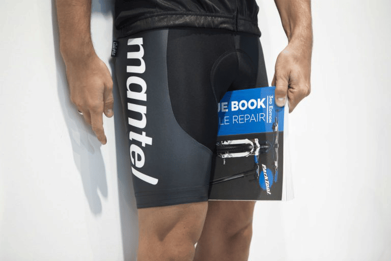 To measure your inseam first hold a book between your legs while standing against a wall.