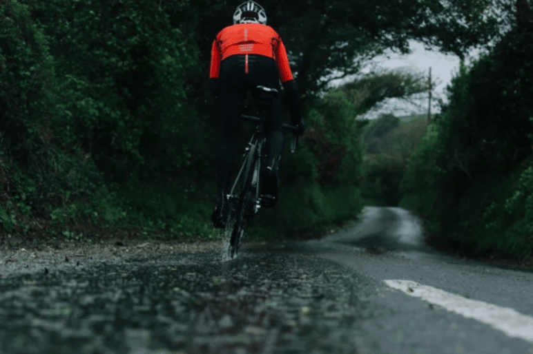 A wet chain lube will be better than a mountain bike wax, for riding in wet weather.