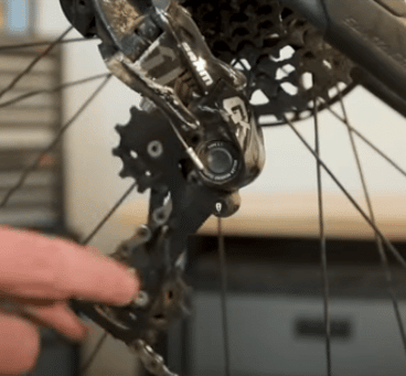 By dropping the derailleur of the bike you are creating more chain slack.