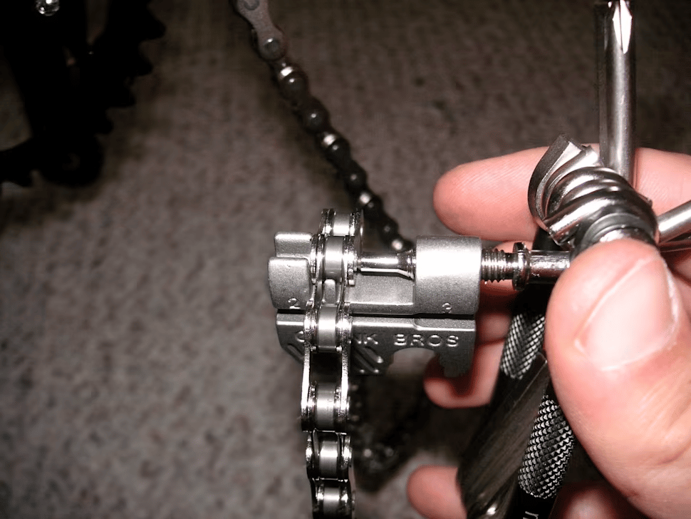 Use a multitool chain breaker to remove the extra links of your mountain bike chain.